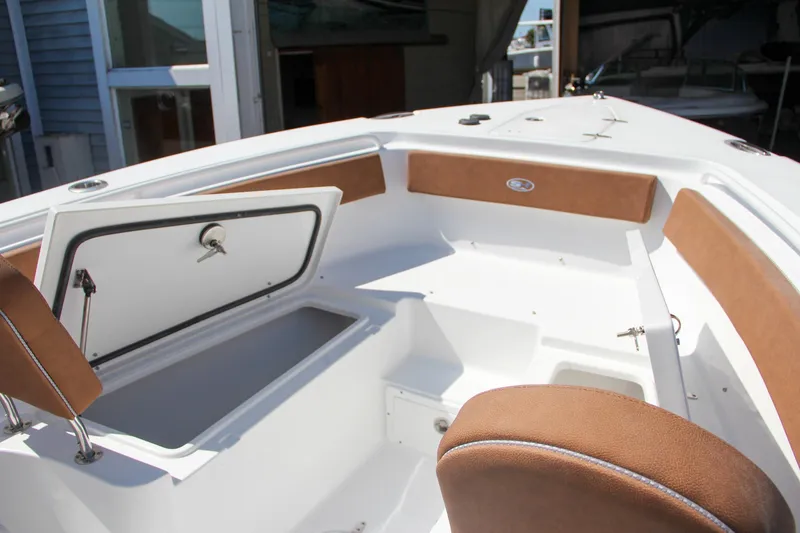 Slide: The Image of 2025 Sea Hunt Gamefish 25 boat interior with open storage compartment and cushioned seating. - 40