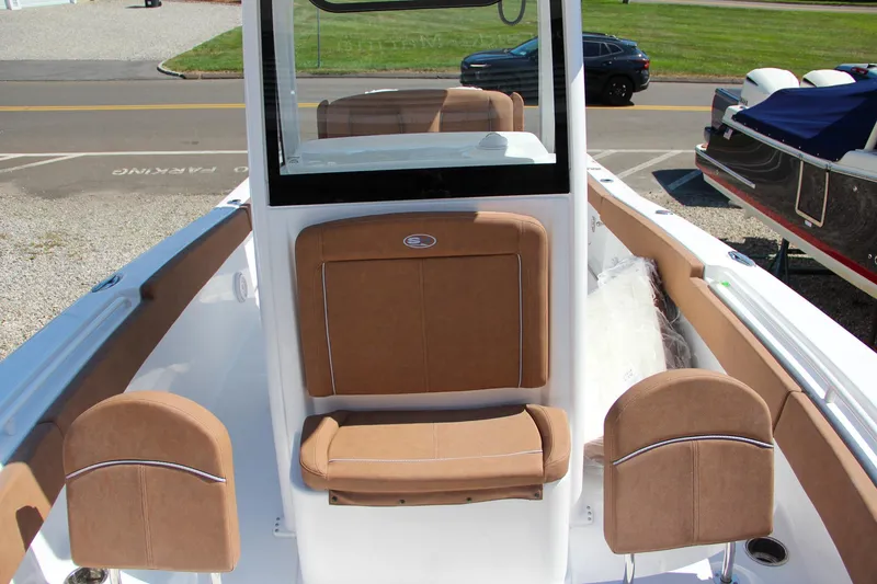 Slide: The Image of 2025 Sea Hunt Gamefish 25 boat interior with tan seating and console. - 46