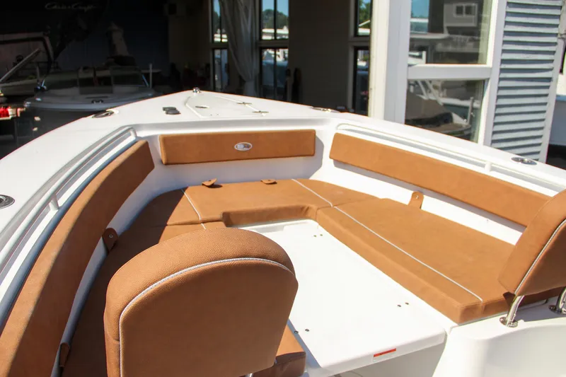 Slide: The Image of 2025 Sea Hunt Gamefish 25 boat interior with tan seating and white deck. - 47