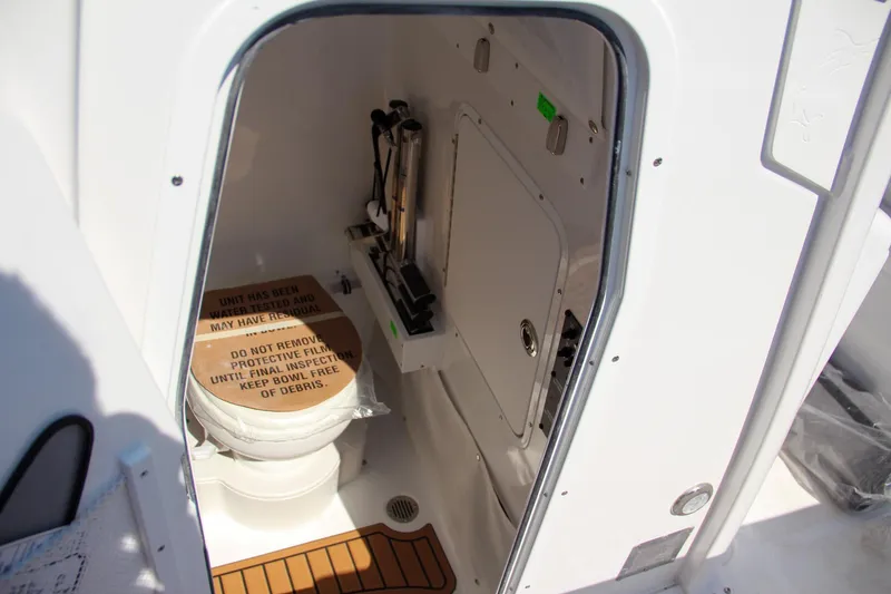 Slide: The Image of 2025 Sea Hunt Gamefish 25 boat interior with compact marine toilet. - 50