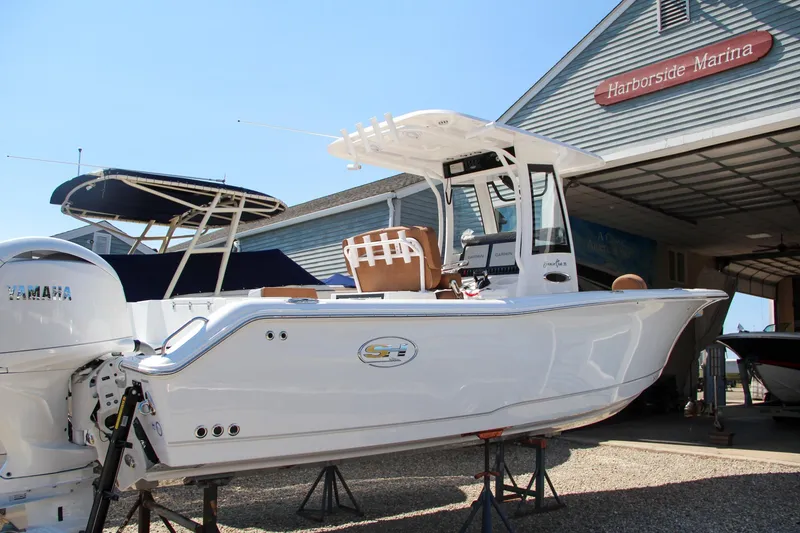 Slide: The Image of 2025 Sea Hunt Gamefish 25 boat at Harborside Marina, displayed on stands. - 7