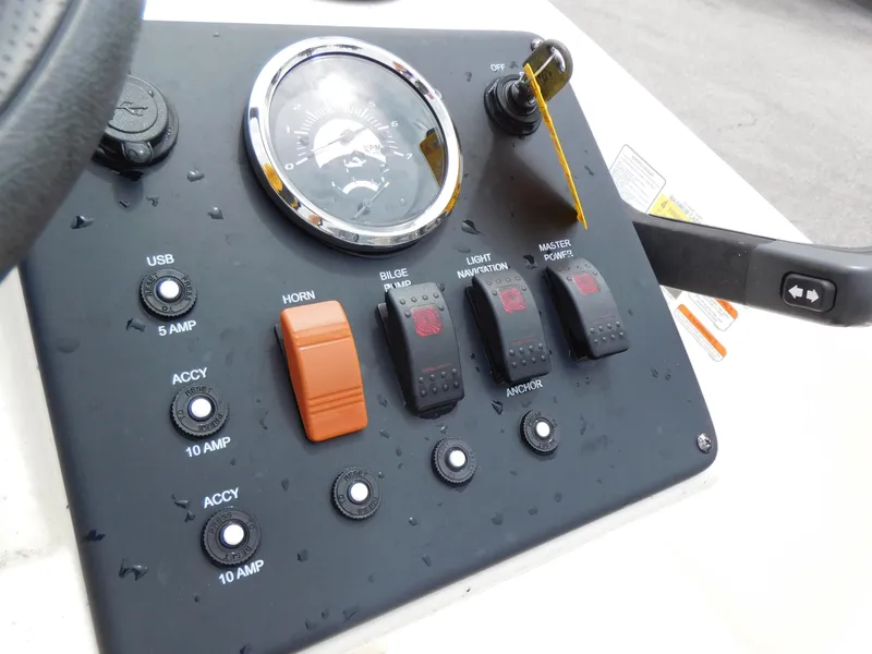 Slide: The Image of Control panel of a 2006 Sea Ray 205 Sport boat with switches and gauges. - 16