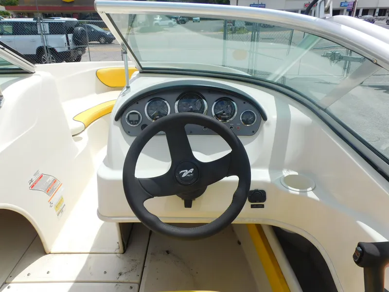 Slide: The Image of 2006 Sea Ray 205 Sport boat dashboard with steering wheel and gauges. - 9