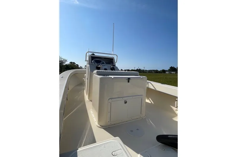 Slide: The Image of 2026 Jones Brothers 20 Cape Fisherman boat, interior view under clear blue sky. - 17