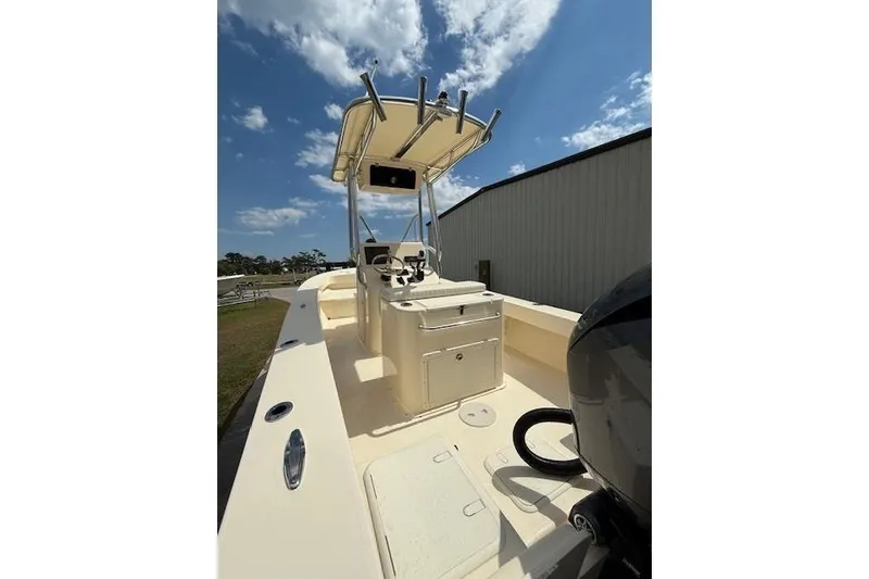 Slide: The Image of 2026 Jones Brothers 20 Cape Fisherman boat with T-top under a partly cloudy sky. - 7