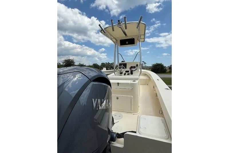 Slide: The Image of 2026 Jones Brothers 20 Cape Fisherman boat with center console and T-top under blue sky. - 8