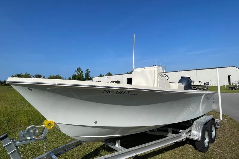 The Image of 2026 Jones Brothers 20 Cape Fisherman boat on trailer, parked outdoors under clear blue sky. - 0
