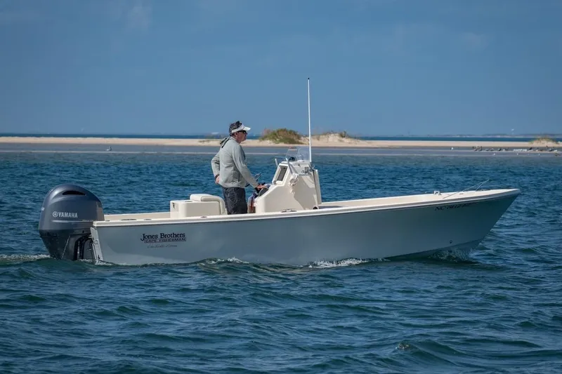 Slide: The Image of 2026 Jones Brothers 20 Cape Fisherman boat on trailer, parked outdoors. - 2