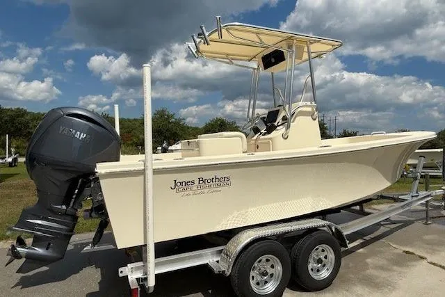 Slide: The Image of 2026 Jones Brothers 20 Cape Fisherman boat with Yamaha engine under a clear sky. - 9