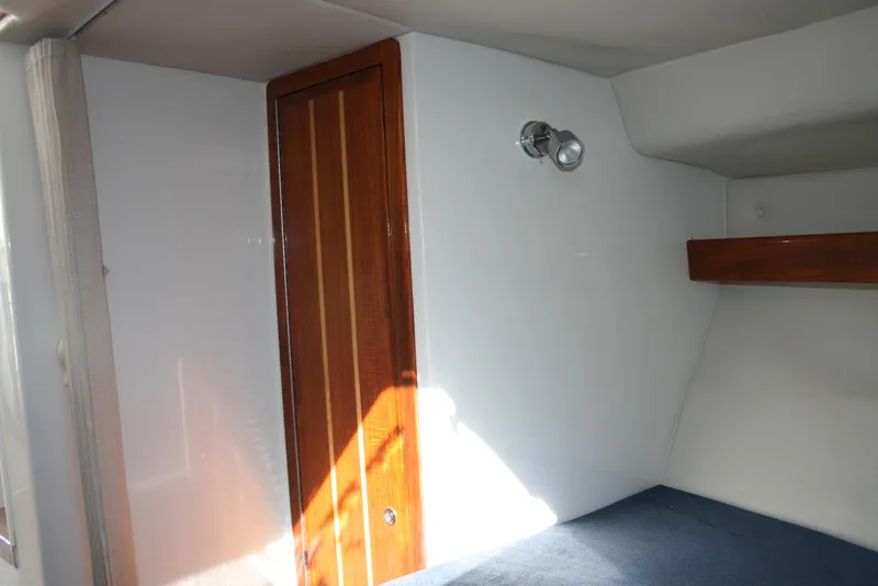 Slide: The Image of Interior cabin of 2005 Ocean Sport Roamer 30', featuring wood door and wall light. - 10