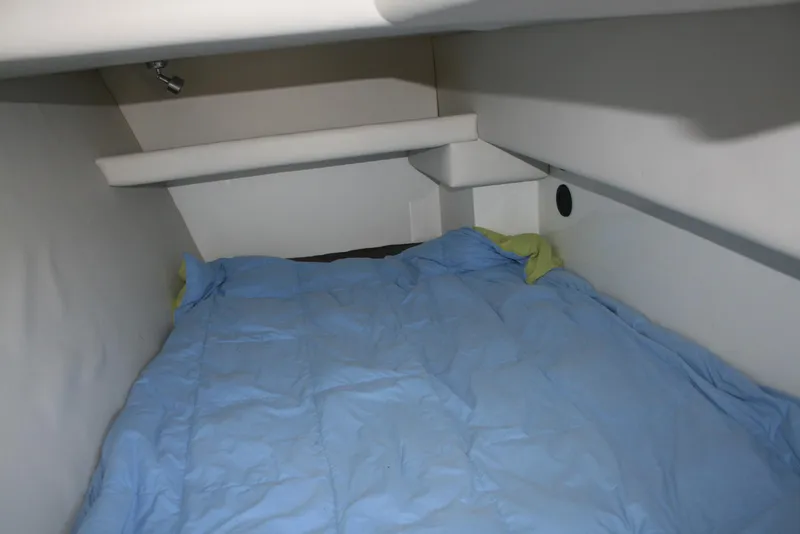 Slide: The Image of Interior cabin of 2005 Ocean Sport Roamer 30' boat with blue bedding. - 11