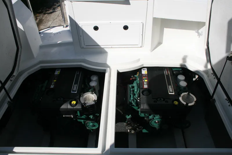 Slide: The Image of Twin engines in a 2005 Ocean Sport Roamer 30' boat, showcasing engine compartment. - 14