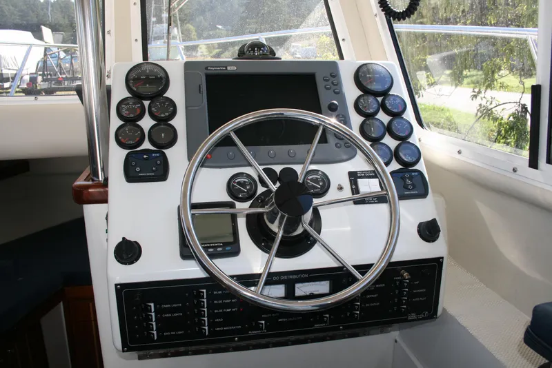 Slide: The Image of Control panel of a 2005 Ocean Sport Roamer 30' #9 boat with steering wheel and gauges. - 3