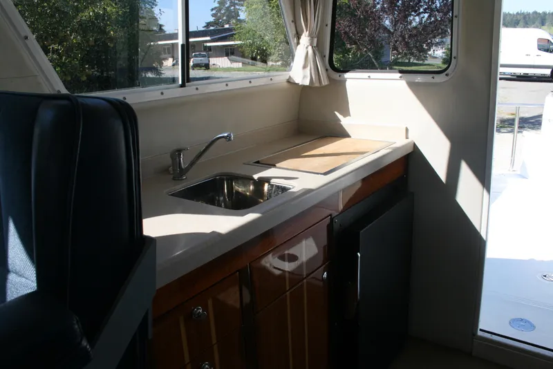 Slide: The Image of Interior of 2005 Ocean Sport Roamer 30' #9, featuring a compact kitchen area. - 8