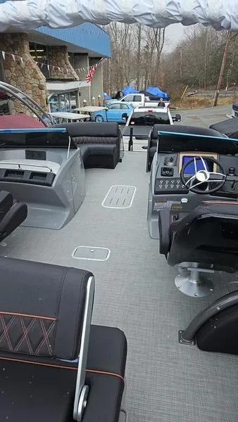 Slide: The Image of 2024 Bennington QX 27 QXSBWA X2 Swingback interior with modern helm and seating. - 2