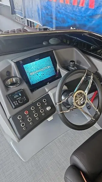 Slide: The Image of 2024 Bennington QX 27 QXSBWA X2 Swingback dashboard with steering wheel and control panel. - 3