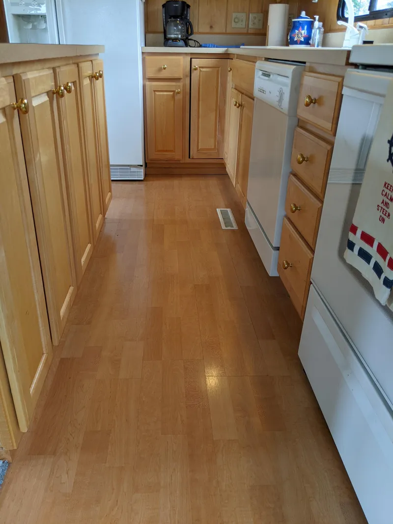 Slide: The Image of 1999 Sumerset 16x78 kitchen with wooden cabinets and modern appliances. - 17