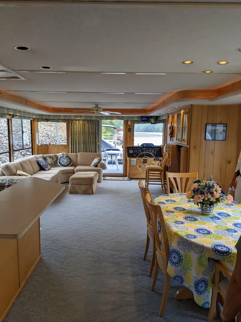 Slide: The Image of Spacious interior of a 1999 Sumerset 16x78 houseboat with cozy seating and dining area. - 21