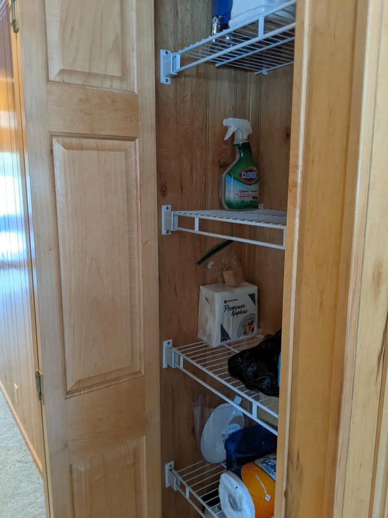 Slide: The Image of Wooden pantry with wire shelves in a 1999 Sumerset 16x78 houseboat. - 24