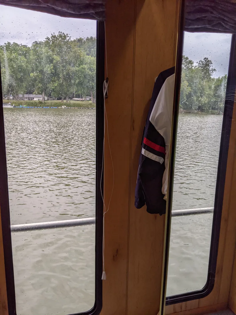 Slide: The Image of View from a 1999 Sumerset 16x78 houseboat window overlooking a serene lake. - 34