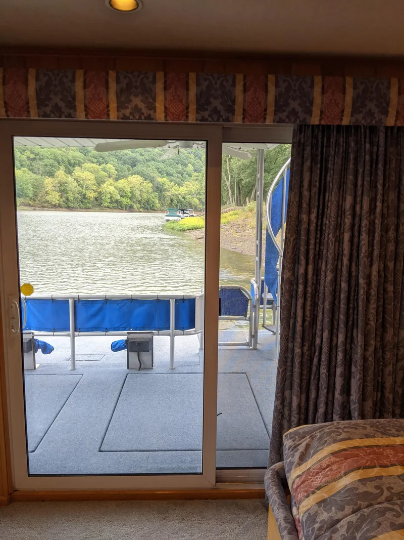 Slide: The Image of View from 1999 Sumerset 16x78 houseboat, overlooking serene lake and lush greenery. - 37