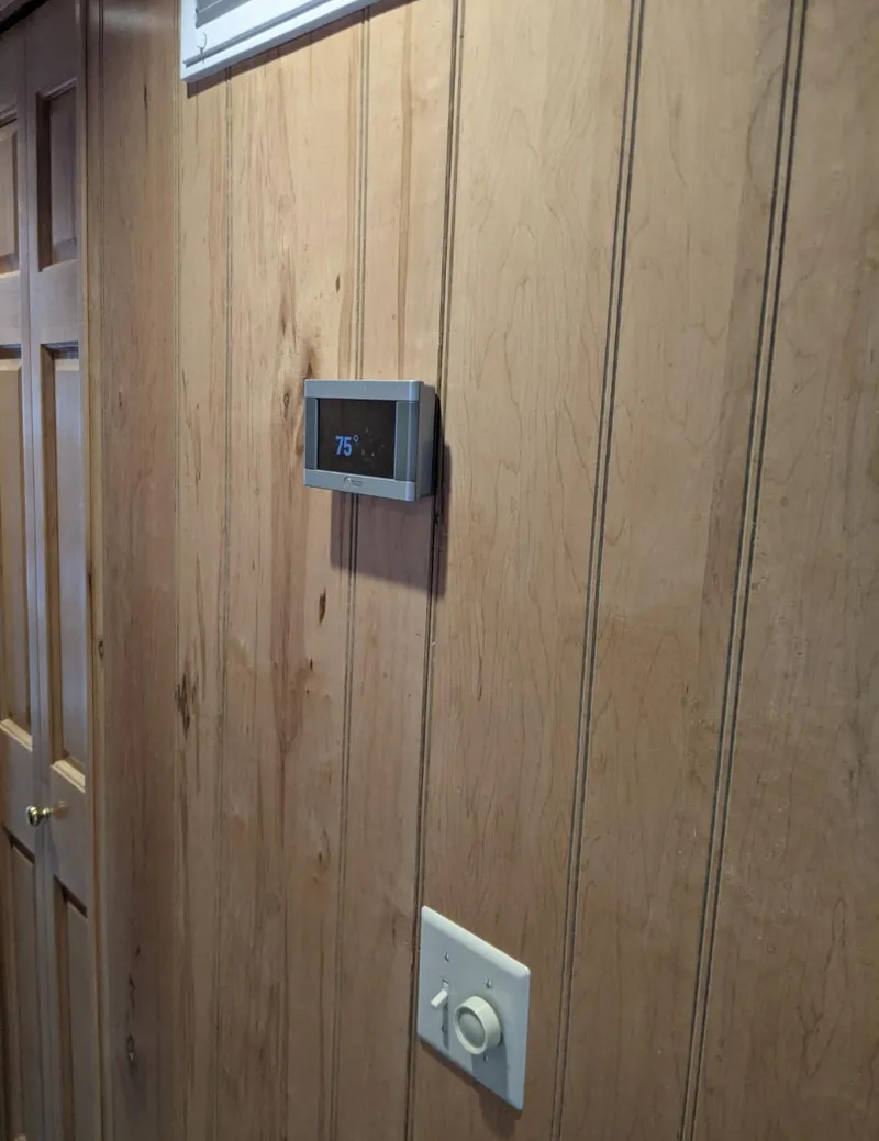 Slide: The Image of Thermostat set to 75°F on wood-paneled wall in 1999 Sumerset 16x78 houseboat. - 48