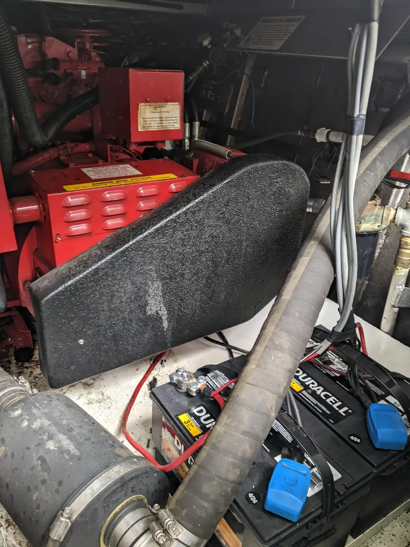 Slide: The Image of Engine compartment of a 1999 Sumerset 16x78 houseboat with batteries and cables. - 49