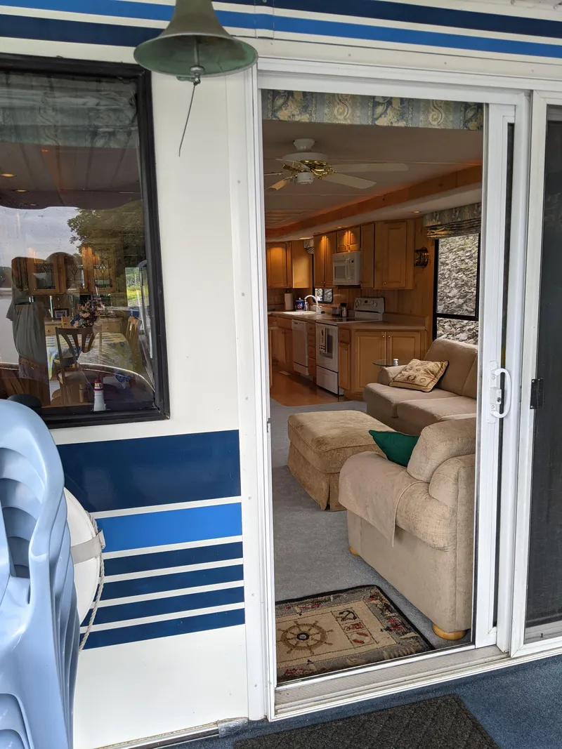 Slide: The Image of Interior view of 1999 Sumerset 16x78 houseboat with cozy living area and kitchen. - 5