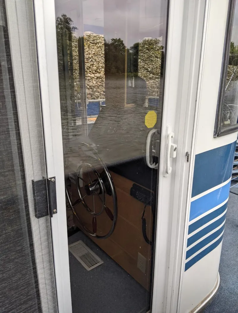 Slide: The Image of Interior view of 1999 Sumerset 16x78 houseboat helm with steering wheel. - 6