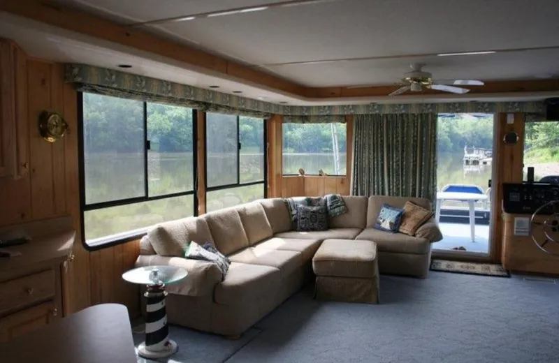 Slide: The Image of Cozy interior of 1999 Sumerset 16x78 houseboat with large windows and sectional sofa. - 7