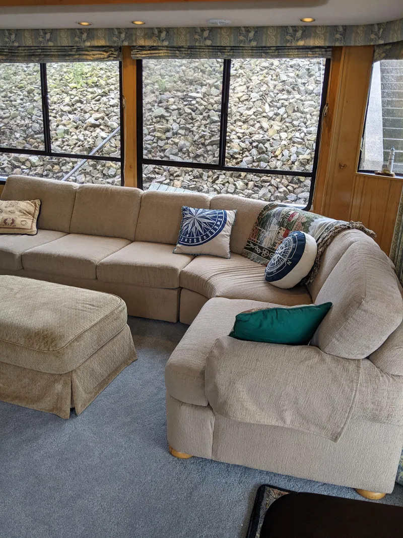 Slide: The Image of Cozy living area in 1999 Sumerset 16x78 houseboat with beige sectional sofa. - 9