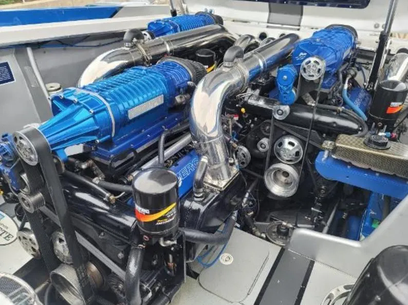 Slide: The Image of Engine compartment of a 2009 Cigarette 46' Rider XP boat, featuring blue and chrome components. - 11