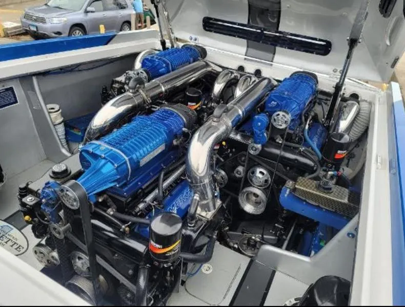 Slide: The Image of Engine compartment of a 2009 Cigarette 46' Rider XP boat, featuring dual blue engines. - 12