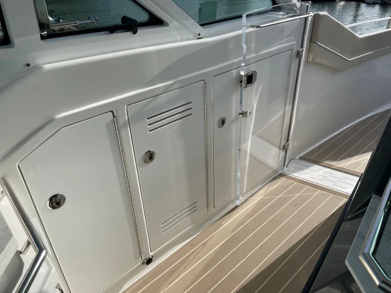 Slide: The Image of 2019 Formula 400 SSC boat interior with sleek white cabinetry and wood-textured flooring. - 11