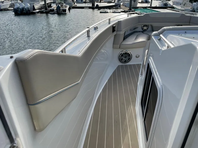 Slide: The Image of 2019 Formula 400 SSC boat deck with cushioned seating and speaker, docked at marina. - 12