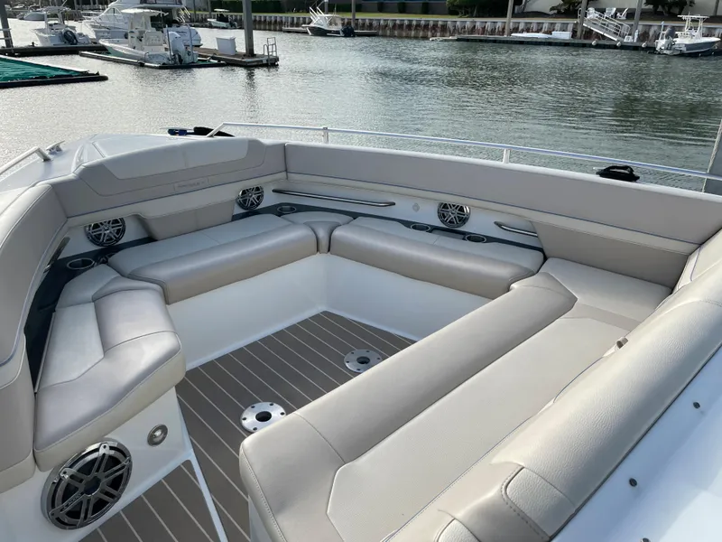 Slide: The Image of Luxurious seating area on a 2019 Formula 400 SSC boat, docked by the water. - 13