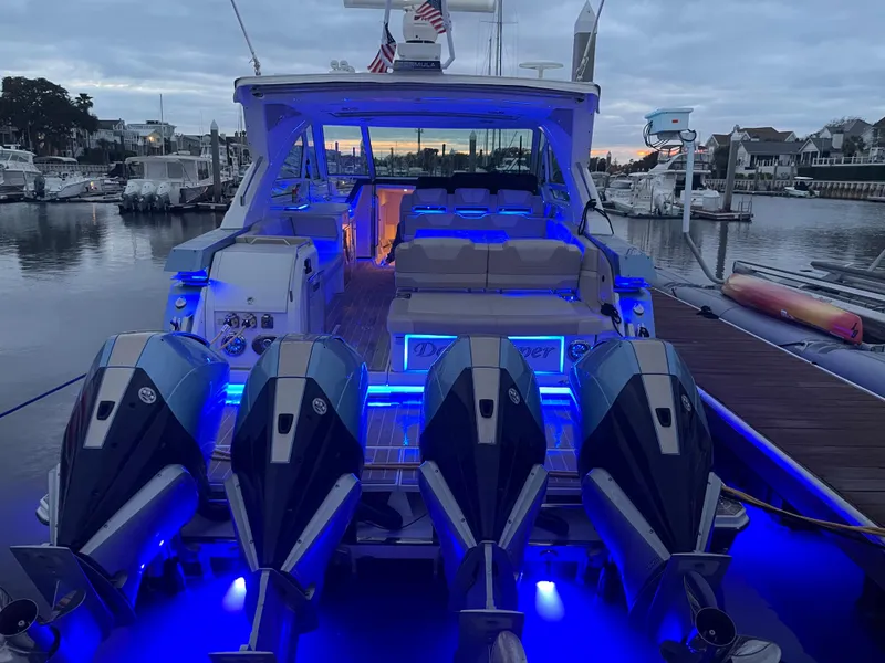 Slide: The Image of 2019 Formula 400 SSC boat with illuminated deck and four powerful engines at a marina. - 21