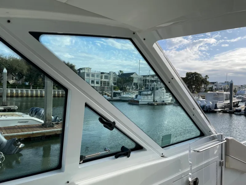 Slide: The Image of View from 2019 Formula 400 SSC boat window overlooking marina with boats and waterfront buildings. - 6