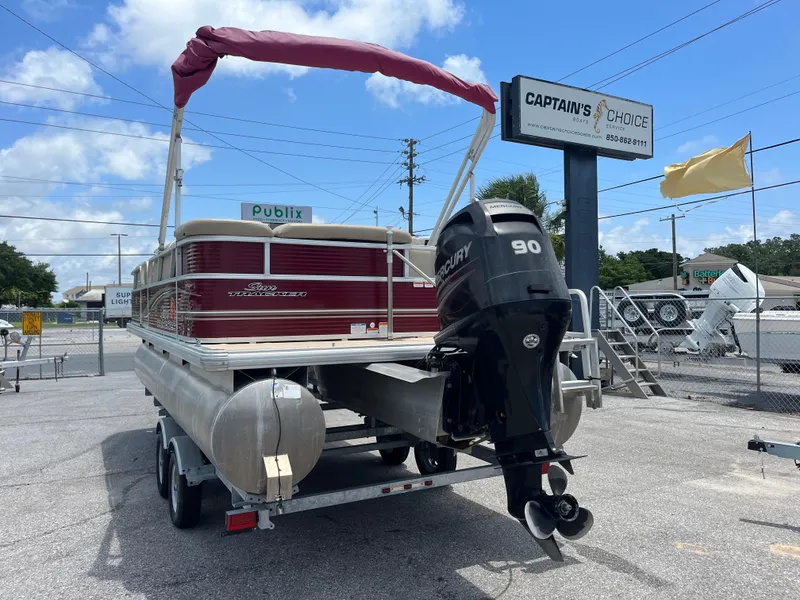 Slide: The Image of 2013 Sun Tracker Party Barge 22 DLX with Mercury 90 engine, parked outdoors. - 3