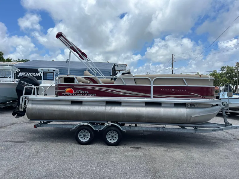 Slide: The Image of 2013 Sun Tracker Party Barge 22 DLX pontoon boat on trailer, parked outdoors. - 5