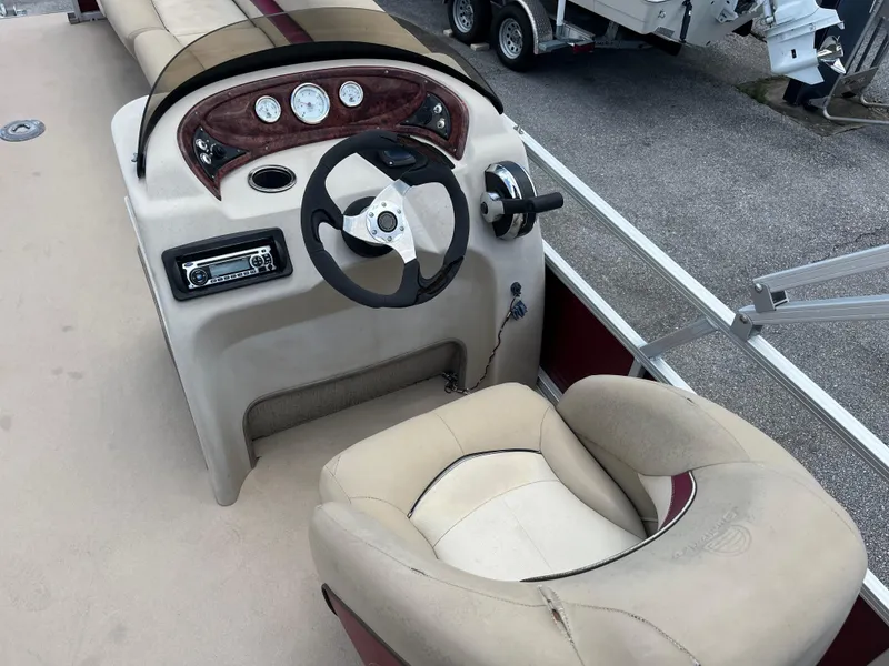 Slide: The Image of 2013 Sun Tracker Party Barge 22 DLX boat interior with steering console and seating. - 8