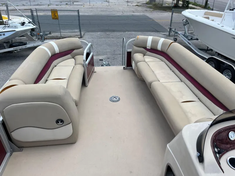 Slide: The Image of 2013 Sun Tracker Party Barge 22 DLX interior with beige and maroon seating. - 9