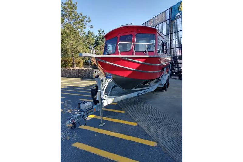 Slide: The Image of Red 2024 Spartan 220 Maximus Pro boat on trailer in outdoor setting. - 6