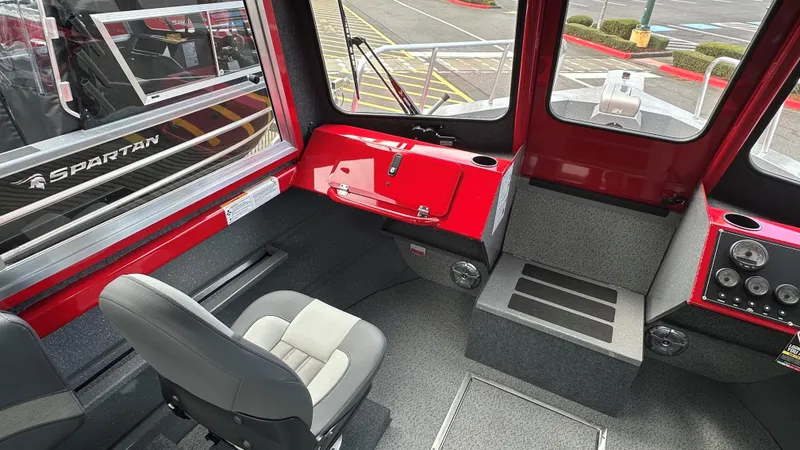 Slide: The Image of 2024 Spartan 220 Maximus Pro interior with textured metal finish and storage compartment. - 5