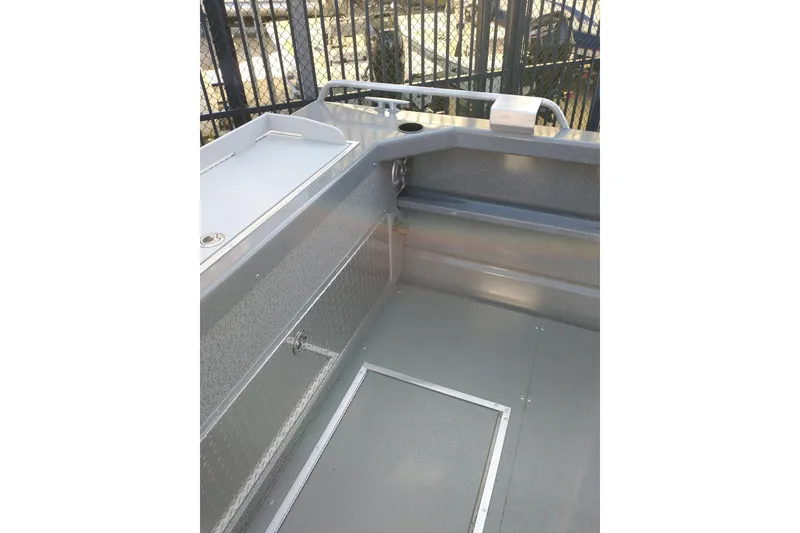 Slide: The Image of Interior view of 2024 Spartan 220 Maximus Pro boat, featuring sleek metal finish and storage compartments. - 10