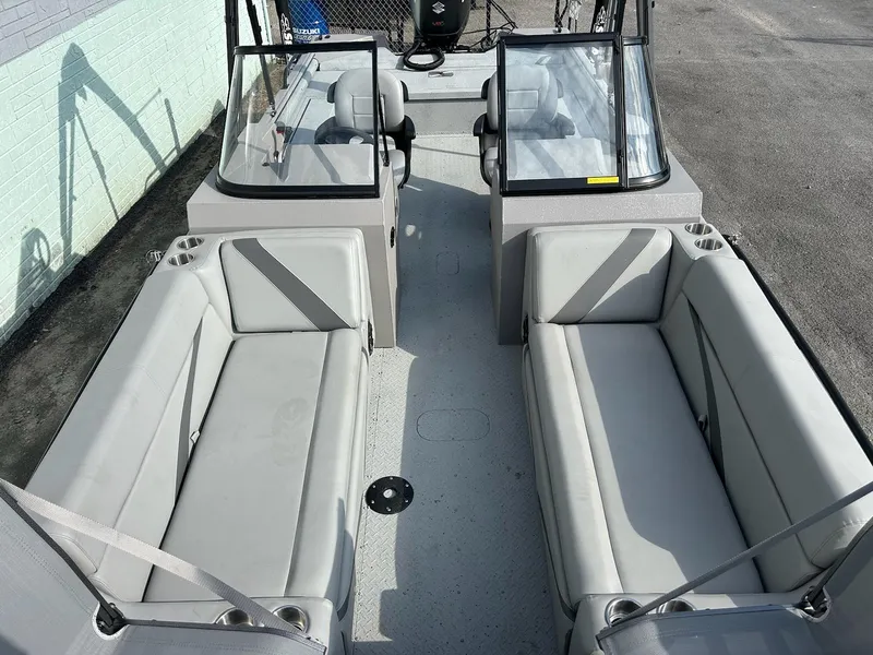 Slide: The Image of 2025 SeaArk EasyCat boat interior with spacious seating and dual windshields. - 4