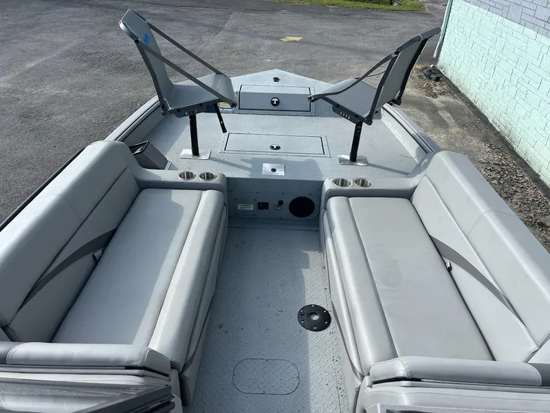Slide: The Image of 2025 SeaArk EasyCat boat interior with gray seating and fishing chairs. - 7