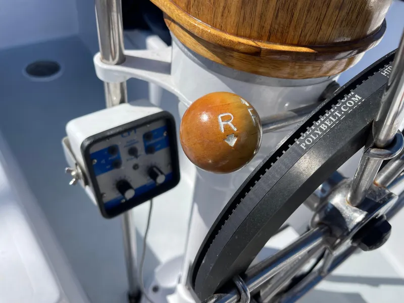 Slide: The Image of Close-up of a 1980 Catalina 38 sailboat helm with control panel and wooden handle. - 29