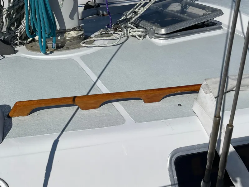 Slide: The Image of Deck of 1980 Catalina 38 sailboat with ropes and wooden handrail. - 35