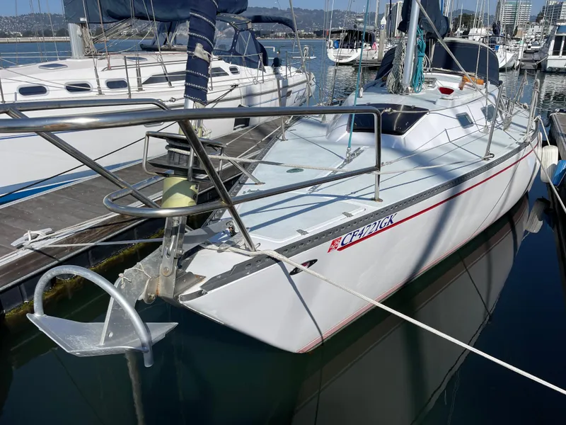 Slide: The Image of 1980 Catalina 38 sailboat docked in marina, featuring sleek design and white hull. - 36